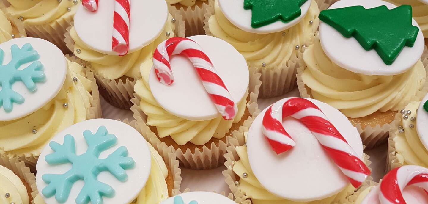 A close up shot of Christmas mini cakes from Chez Nous Corporate Catering. Includes candy canes, christmas trees and snow flakes.